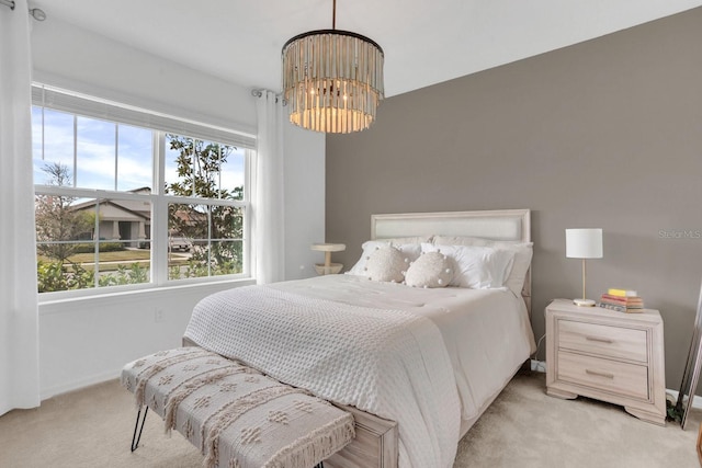 carpeted bedroom with an inviting chandelier