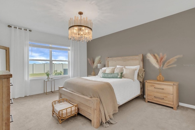 bedroom featuring light carpet and a notable chandelier