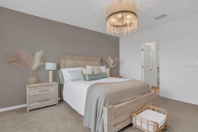 bedroom featuring light carpet and a chandelier