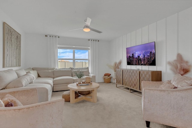 carpeted living room with ceiling fan