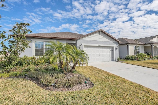 view of front of home featuring an attached garage, concrete driveway, stucco siding, and a front lawn