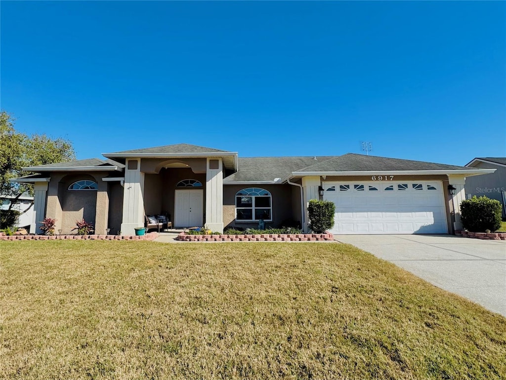 view of front facade with a front yard and a garage