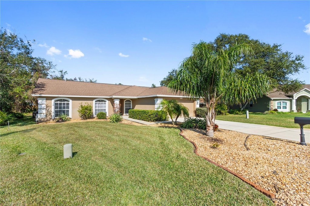 ranch-style home with a front yard