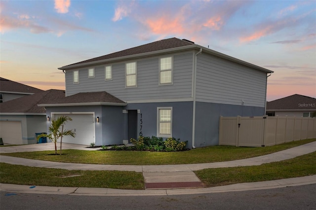 view of front of house with a yard and a garage