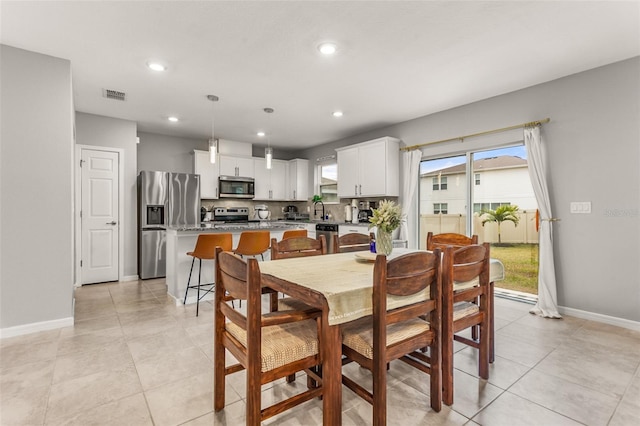 dining area featuring light tile patterned floors