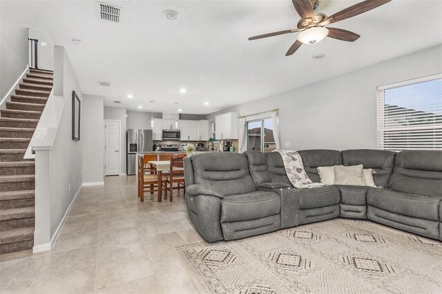 tiled living room with ceiling fan