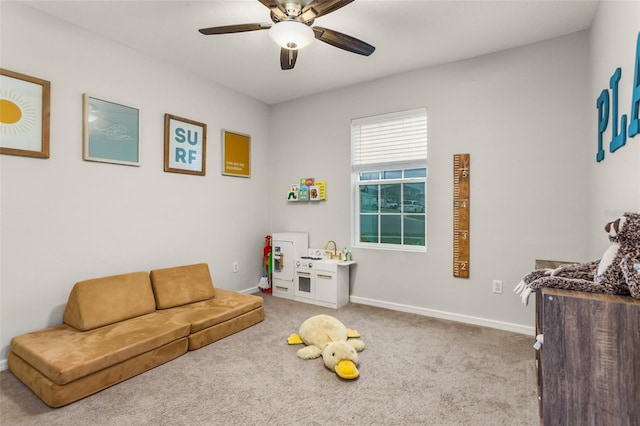 playroom featuring ceiling fan and carpet floors