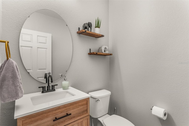 bathroom featuring toilet and vanity