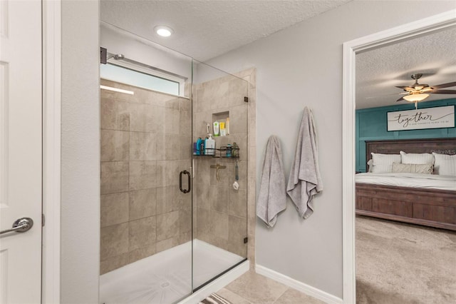 bathroom with a textured ceiling, walk in shower, and ceiling fan