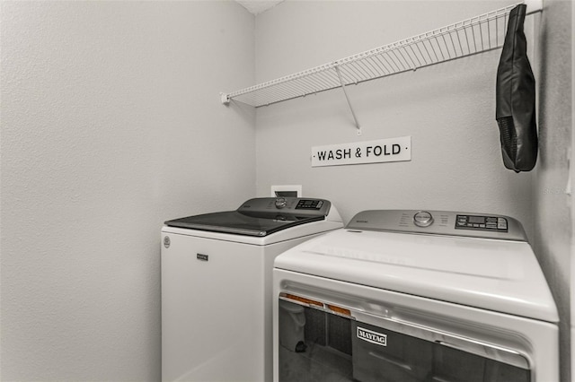 washroom with independent washer and dryer