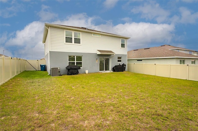 back of house with a lawn and cooling unit