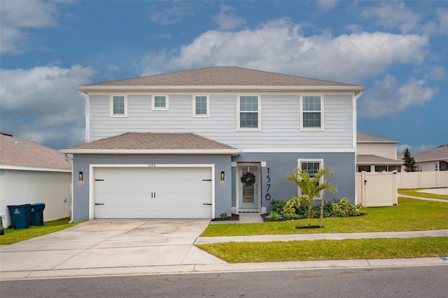 front of property featuring a front yard and a garage