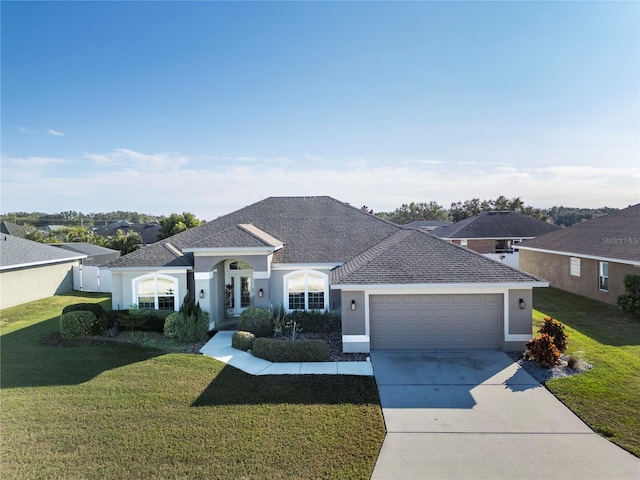 ranch-style home featuring a front lawn and a garage