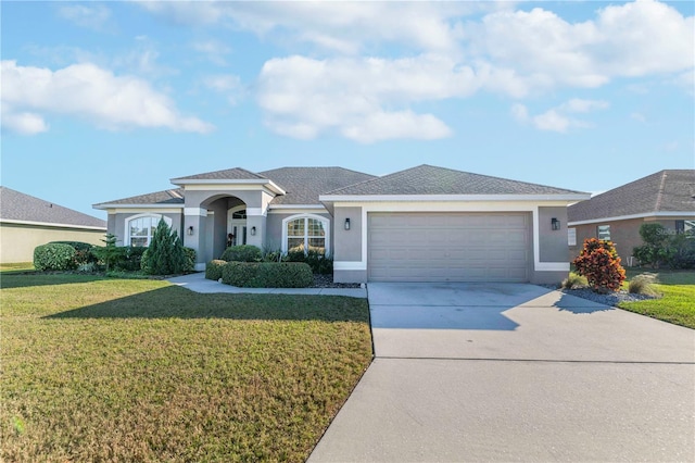 view of front facade with a front yard and a garage