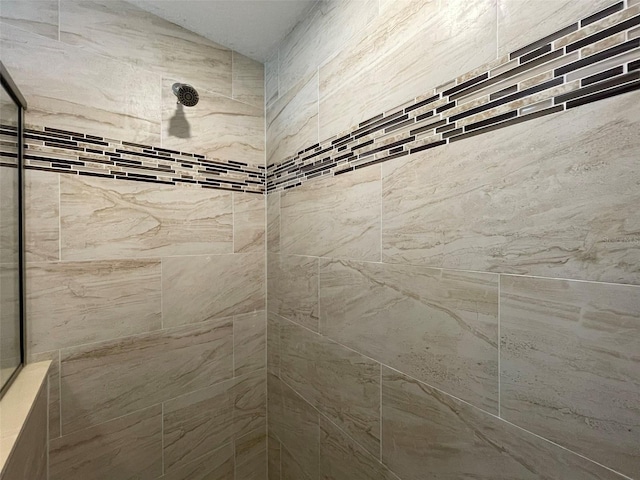 bathroom with tiled shower