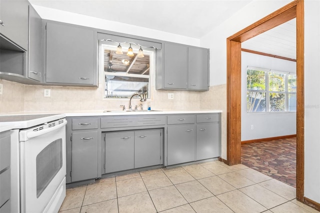 kitchen featuring gray cabinets, white electric stove, light tile patterned floors, and sink