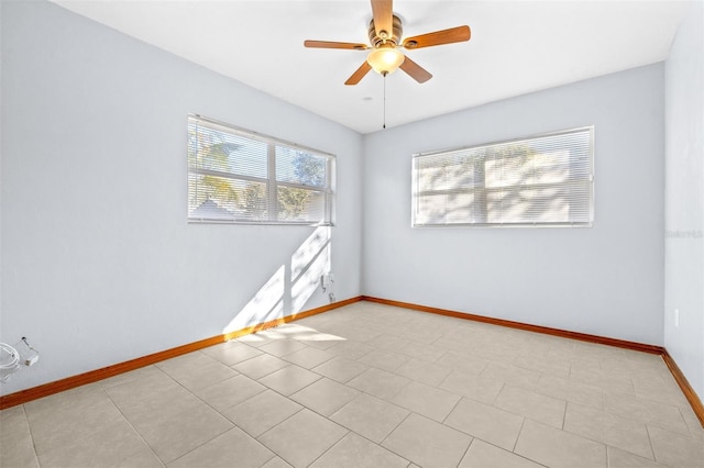 empty room featuring ceiling fan and light tile patterned floors