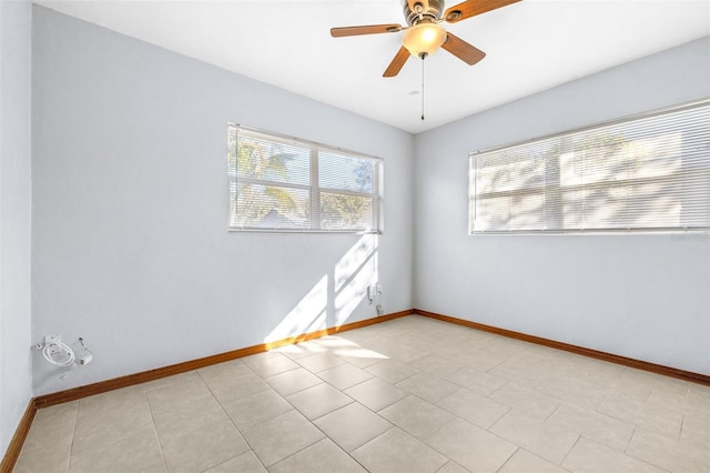 tiled spare room with ceiling fan