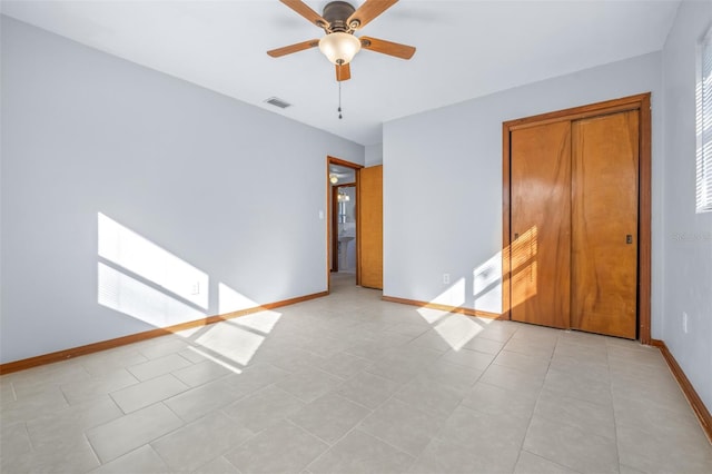 unfurnished bedroom featuring ceiling fan and light tile patterned floors