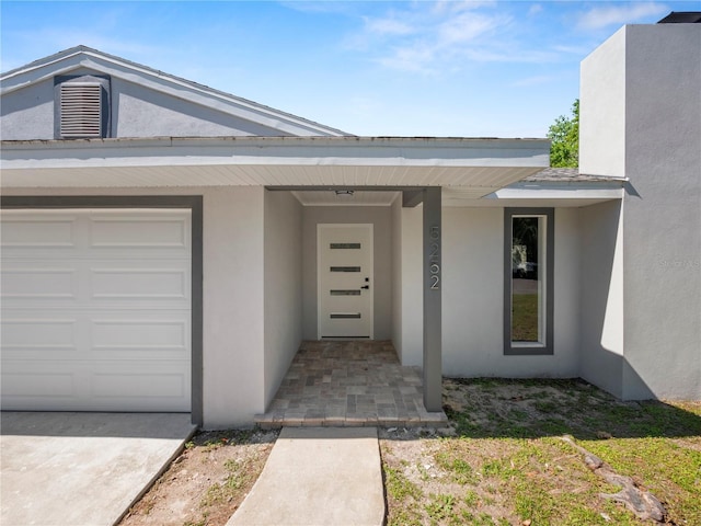 view of exterior entry with a garage