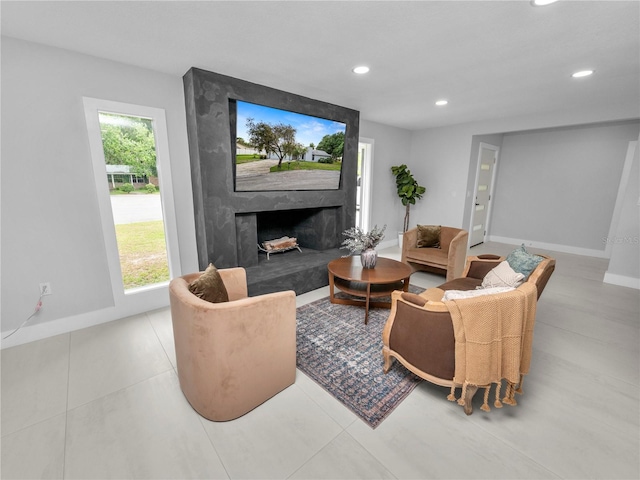 living room featuring a fireplace and plenty of natural light