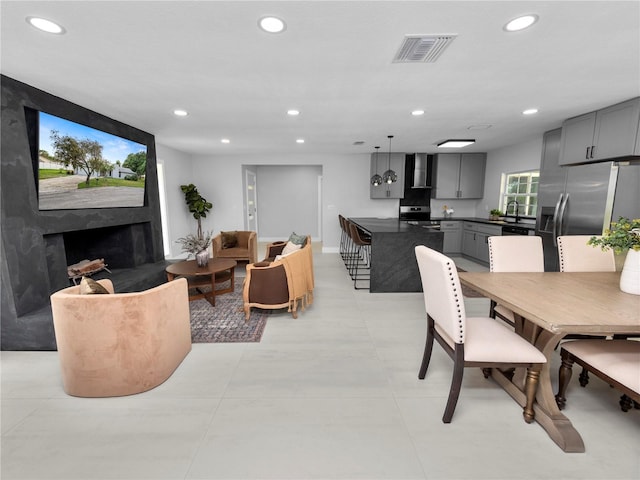 dining space featuring a premium fireplace and sink