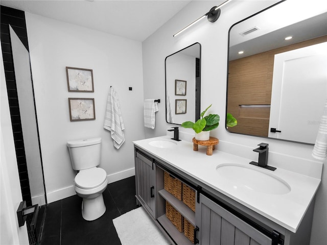 bathroom featuring tile patterned flooring, vanity, and toilet