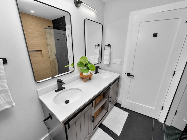 bathroom featuring a tile shower, tile patterned floors, and vanity