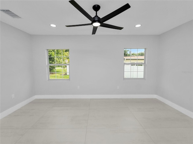 empty room with light tile patterned flooring and ceiling fan