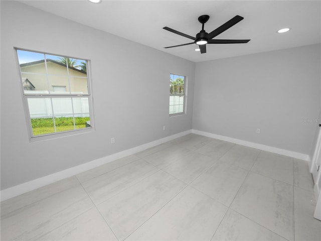 unfurnished room with ceiling fan and light tile patterned floors