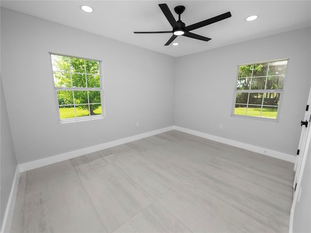 spare room featuring ceiling fan and plenty of natural light