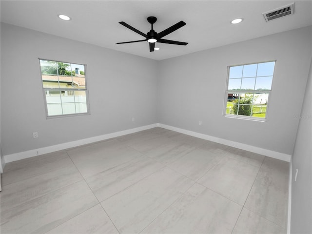 unfurnished room with ceiling fan and light tile patterned floors