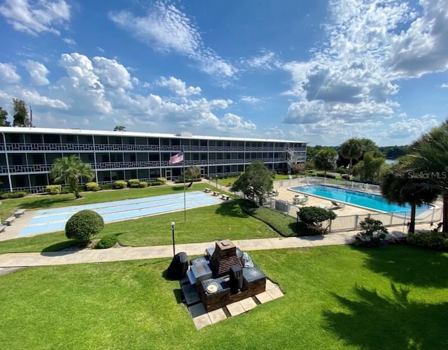 exterior space with a swimming pool and a yard