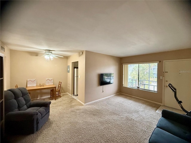 living room with ceiling fan and carpet