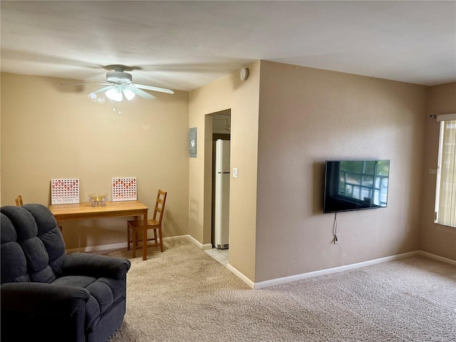 carpeted living room with ceiling fan