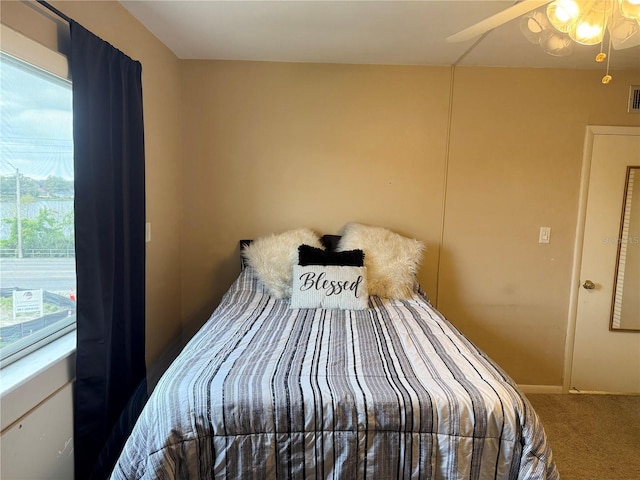 carpeted bedroom featuring ceiling fan