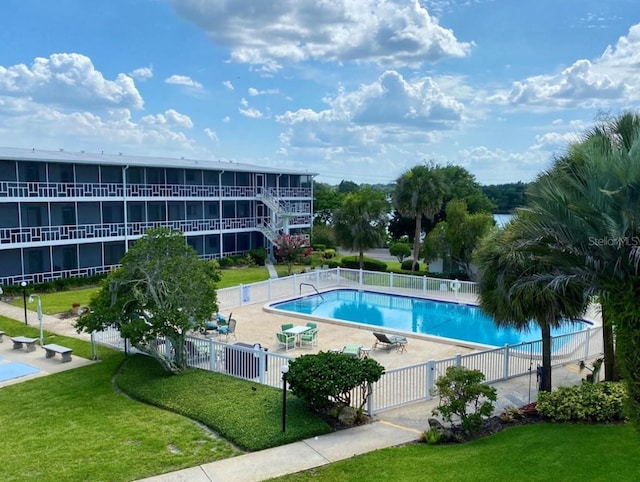 view of swimming pool with a lawn and a patio