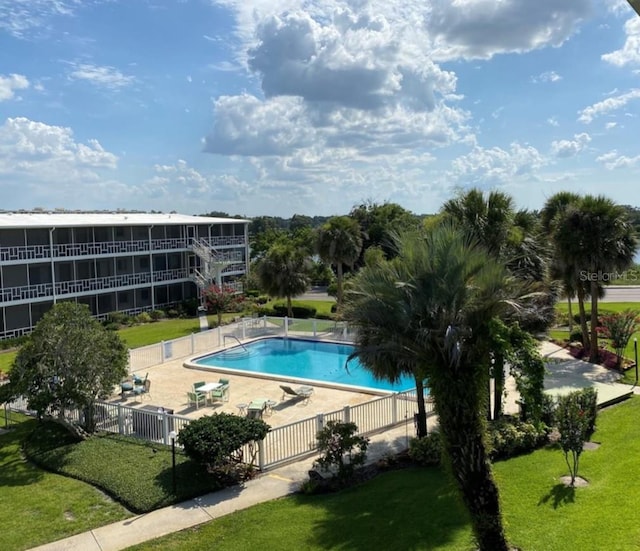 view of swimming pool with a lawn and a patio