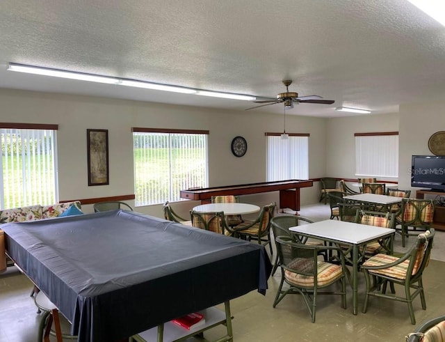 recreation room featuring ceiling fan, plenty of natural light, pool table, and a textured ceiling