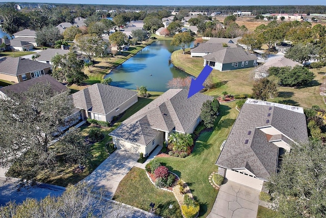 bird's eye view featuring a water view and a residential view