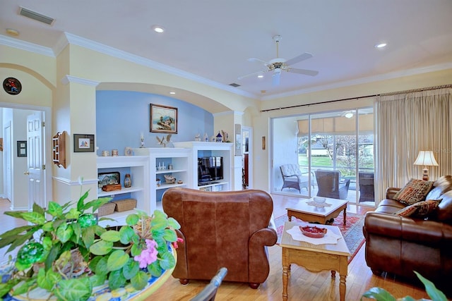 living room featuring ceiling fan, ornamental molding, and light hardwood / wood-style flooring