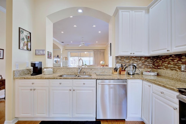 kitchen featuring stainless steel dishwasher, white cabinets, sink, and ceiling fan