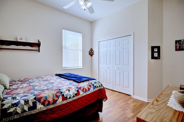 bedroom with hardwood / wood-style flooring, ceiling fan, and a closet