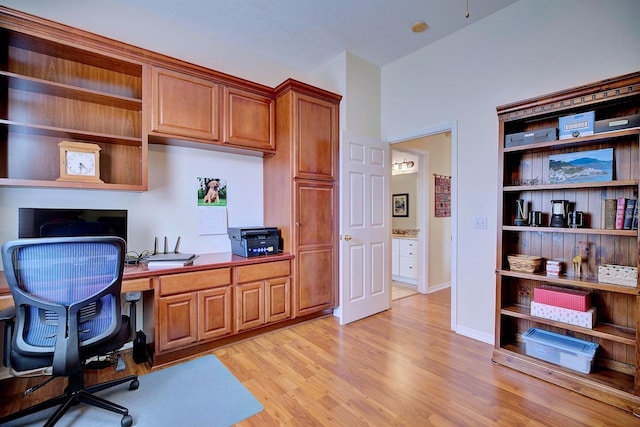 office area featuring built in desk and light hardwood / wood-style floors