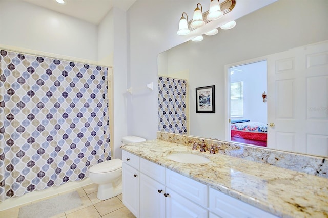 bathroom with tile patterned flooring, vanity, and toilet