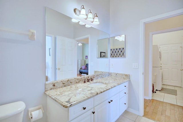 bathroom featuring tile patterned flooring, vanity, and toilet