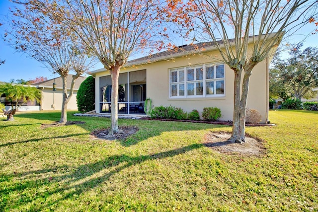 single story home featuring a front yard and a sunroom