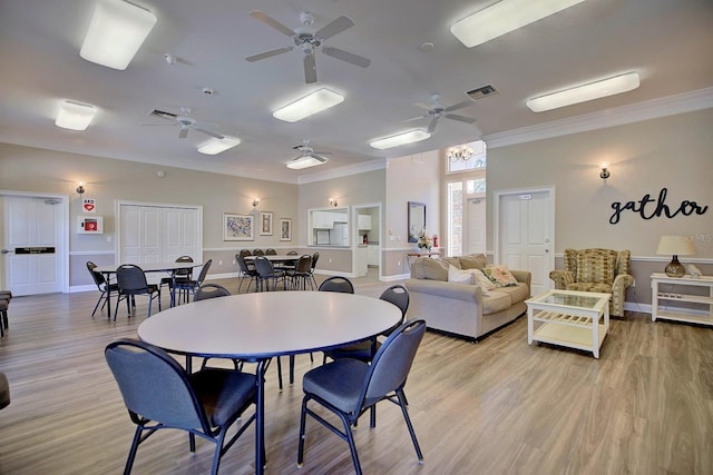 dining room featuring ornamental molding, ceiling fan, and light hardwood / wood-style flooring