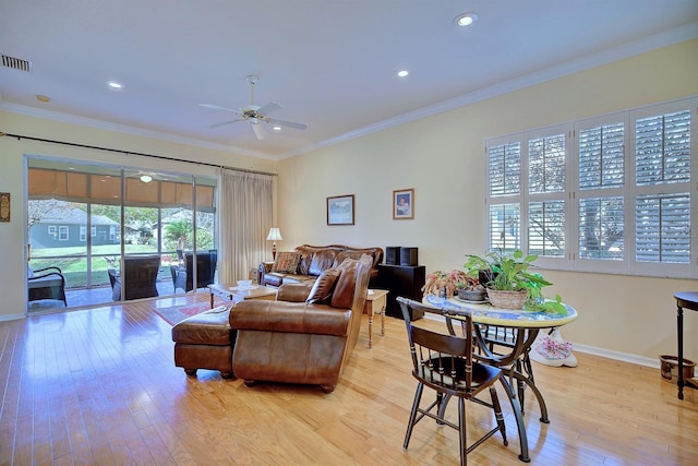 living room with light wood-type flooring, ceiling fan, and ornamental molding