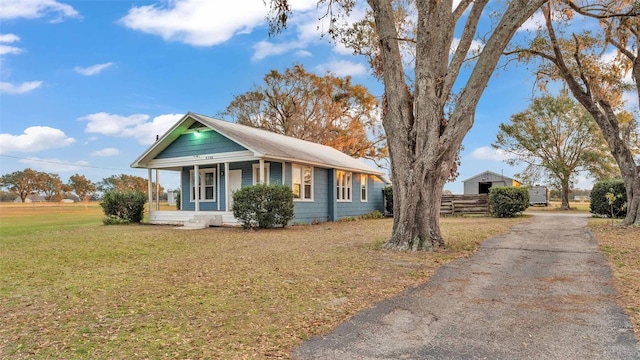 view of front of house with covered porch and a front lawn